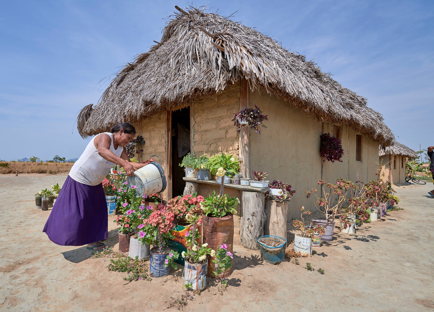 Celestina Fernandes da Silva, a Catholic activist, waters flowers in front of her home in the Wapishana indigenous village of Tabalascada, Brazil, April 3, 2019. Franciscan Father Joao Messias Sousa, who works among indigenous in the Amazon, said the people believe “God is in all things, but those things are not gods.”